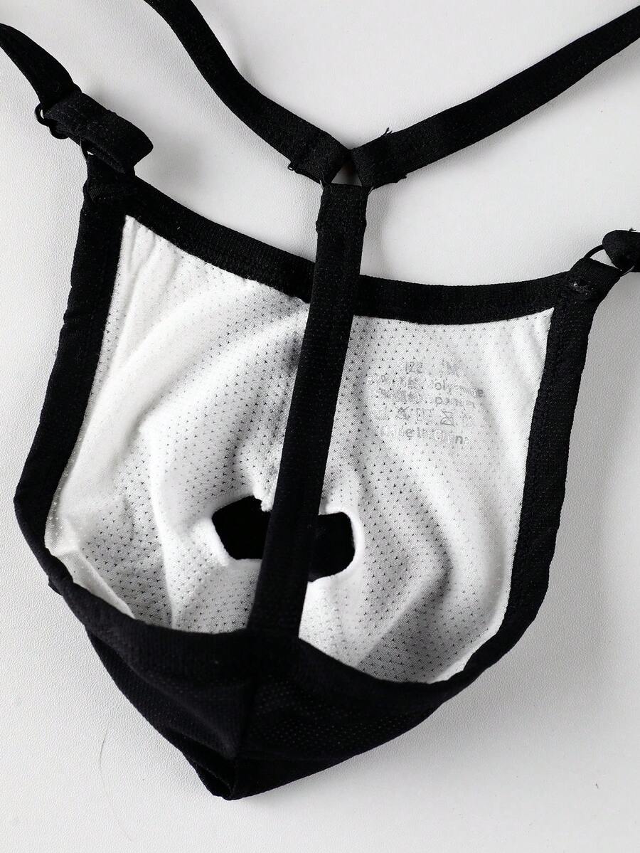 Black low rise men's thong featuring contrast binding detailing and a plain solid design.