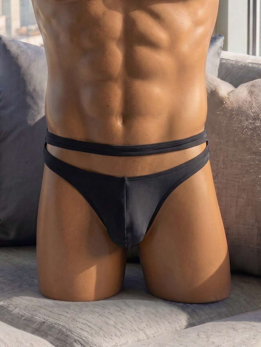 Plain black men's low rise thong underwear crafted from stretch knitted fabric.