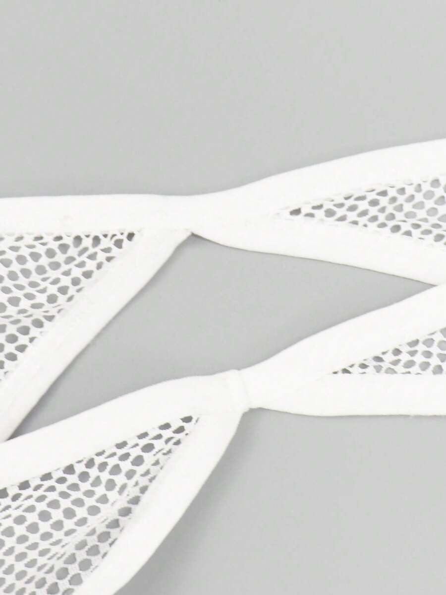 White men's low rise hollow out mesh jockstrap featuring contrast lace detailing and a scoop neck.