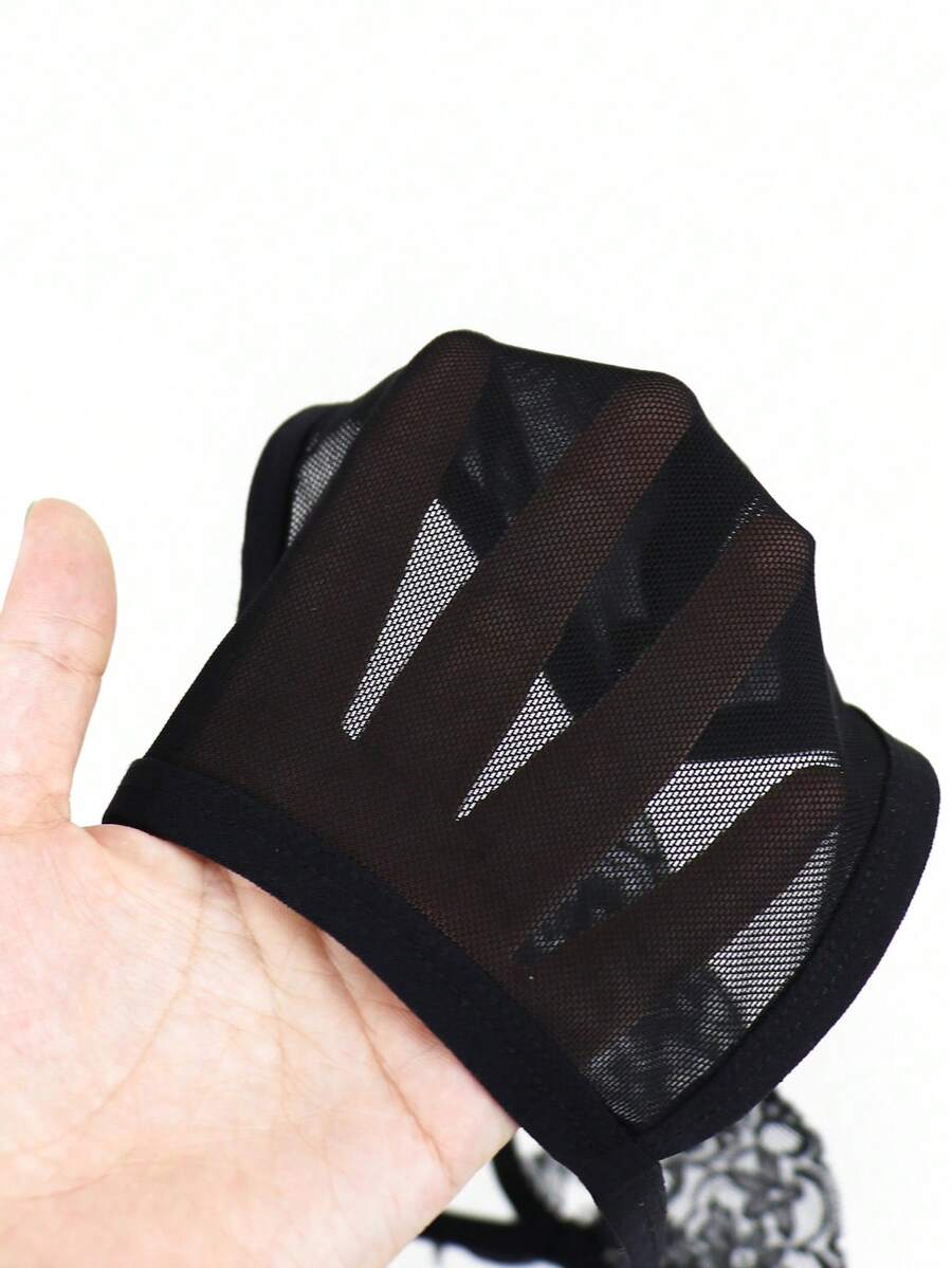 Men's black mesh thong underwear featuring lace trim and bow accent