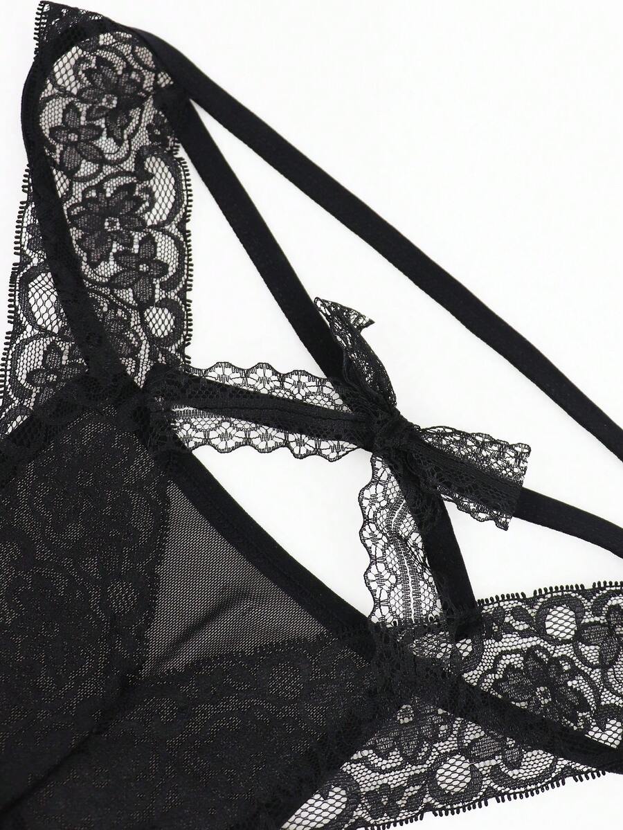 Men's black mesh thong underwear featuring lace trim and bow accent