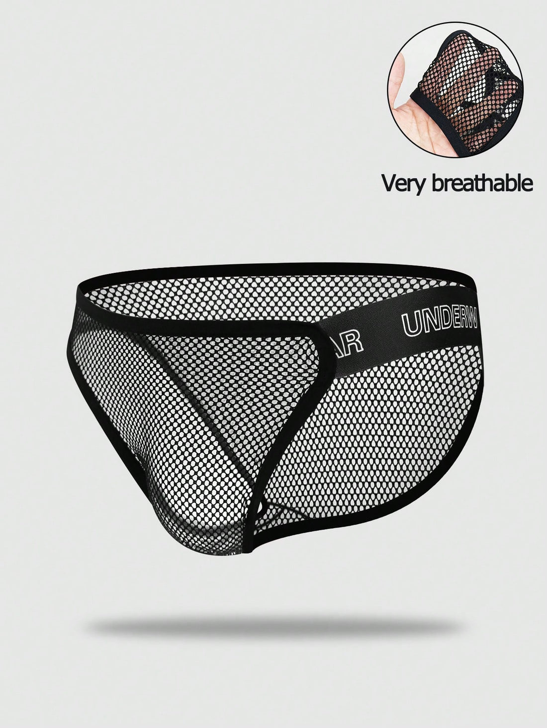 Black men's thong underwear featuring mesh fabric, cut out details, letter pattern, and a low rise fit.