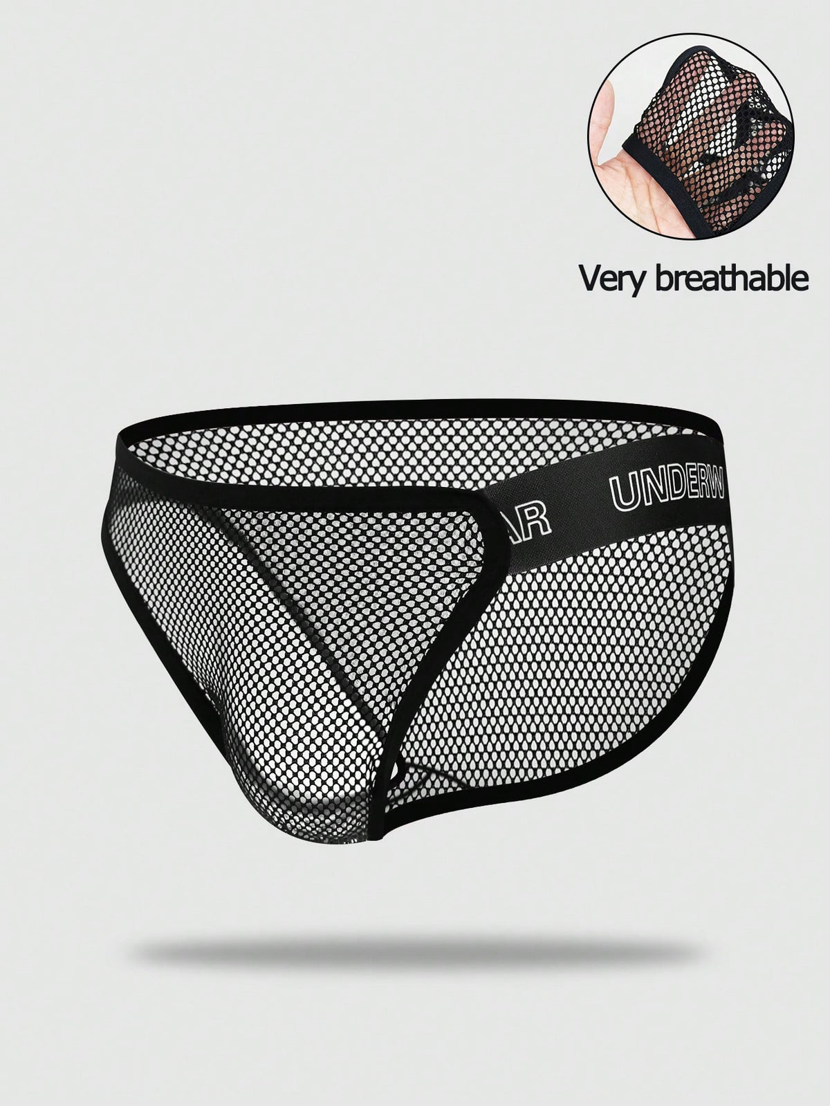 Black men's thong underwear featuring mesh fabric, cut out details, letter pattern, and a low rise fit.