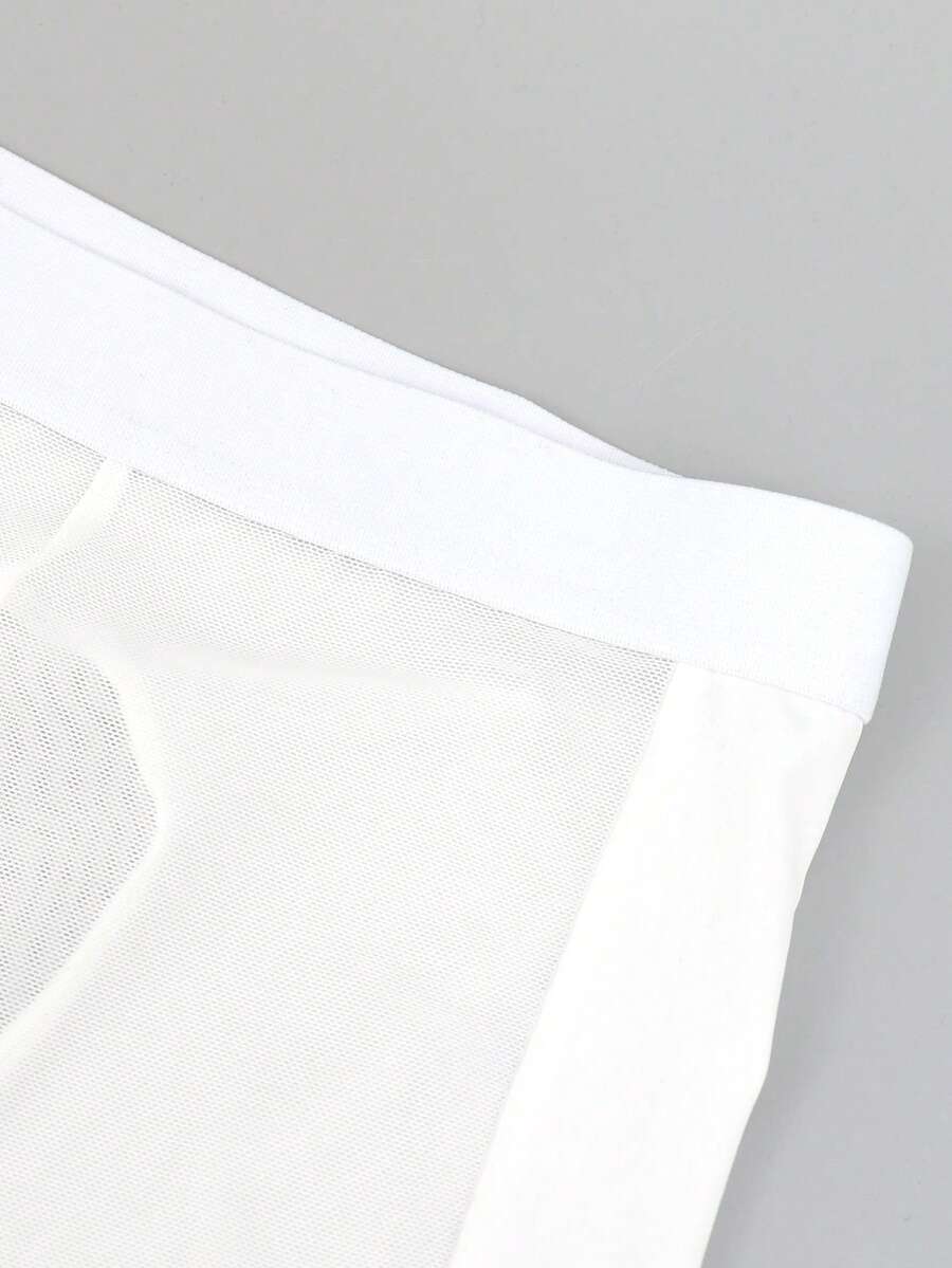 White men's low-rise mesh contrast boxer shorts featuring a plain patchwork design made of stretch fabric.
