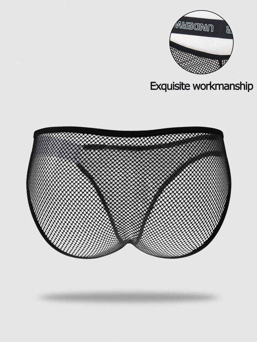 Black men's thong underwear featuring mesh fabric, cut out details, letter pattern, and a low rise fit.