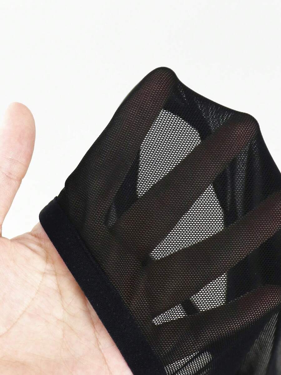 Black men's low rise mesh thong underwear featuring a backless design, sheer fabric, cup detail, and medium stretch material.