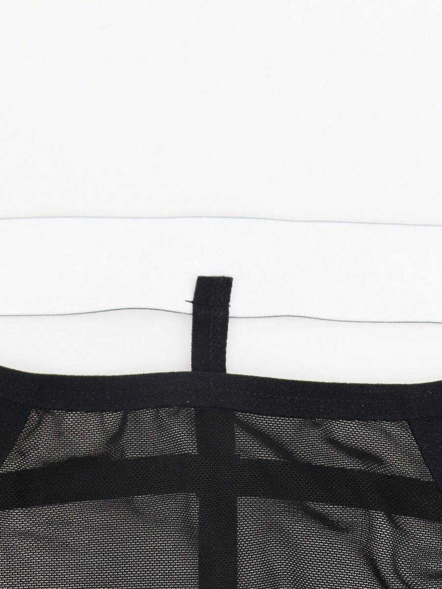 Black men's low rise mesh thong underwear featuring a backless design, sheer fabric, cup detail, and medium stretch material.