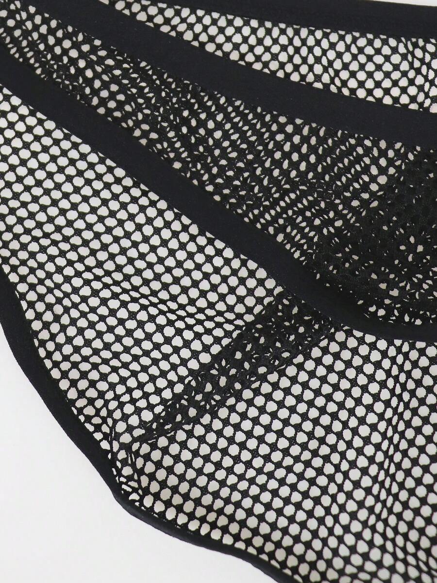 Black men's thong underwear featuring mesh fabric, cut out details, letter pattern, and a low rise fit.