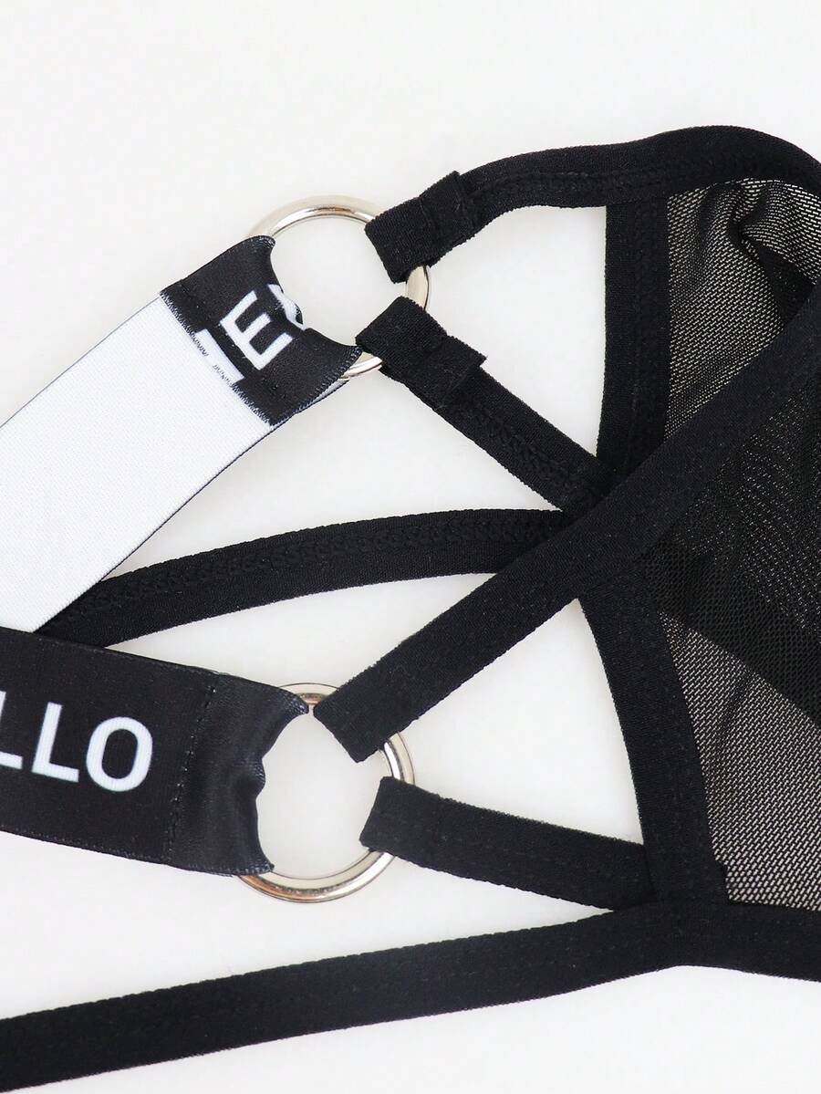 Black men's low rise mesh thong underwear featuring a backless design, sheer fabric, cup detail, and medium stretch material.