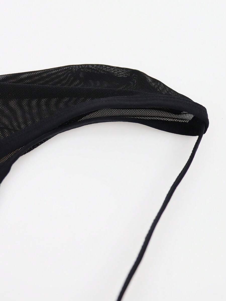 Black men's low rise mesh thong underwear featuring a backless design, sheer fabric, cup detail, and medium stretch material.