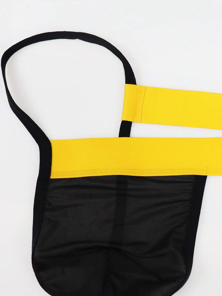 Black low rise men's thong underwear with embroidery detail on knitted fabric.
