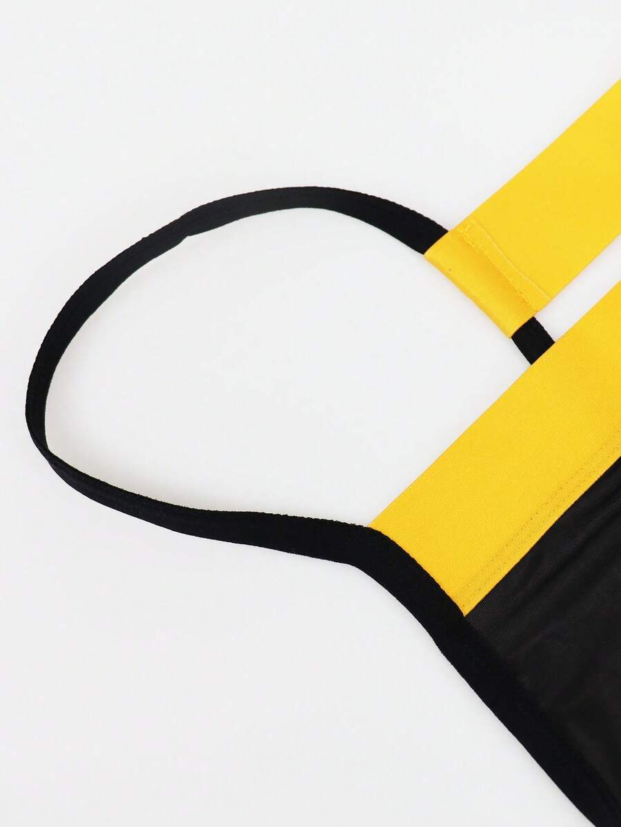 Black low rise men's thong underwear with embroidery detail on knitted fabric.