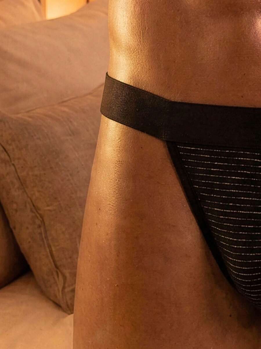 Black men's ice silk high cut briefs featuring a low rise waist and colorblock design.