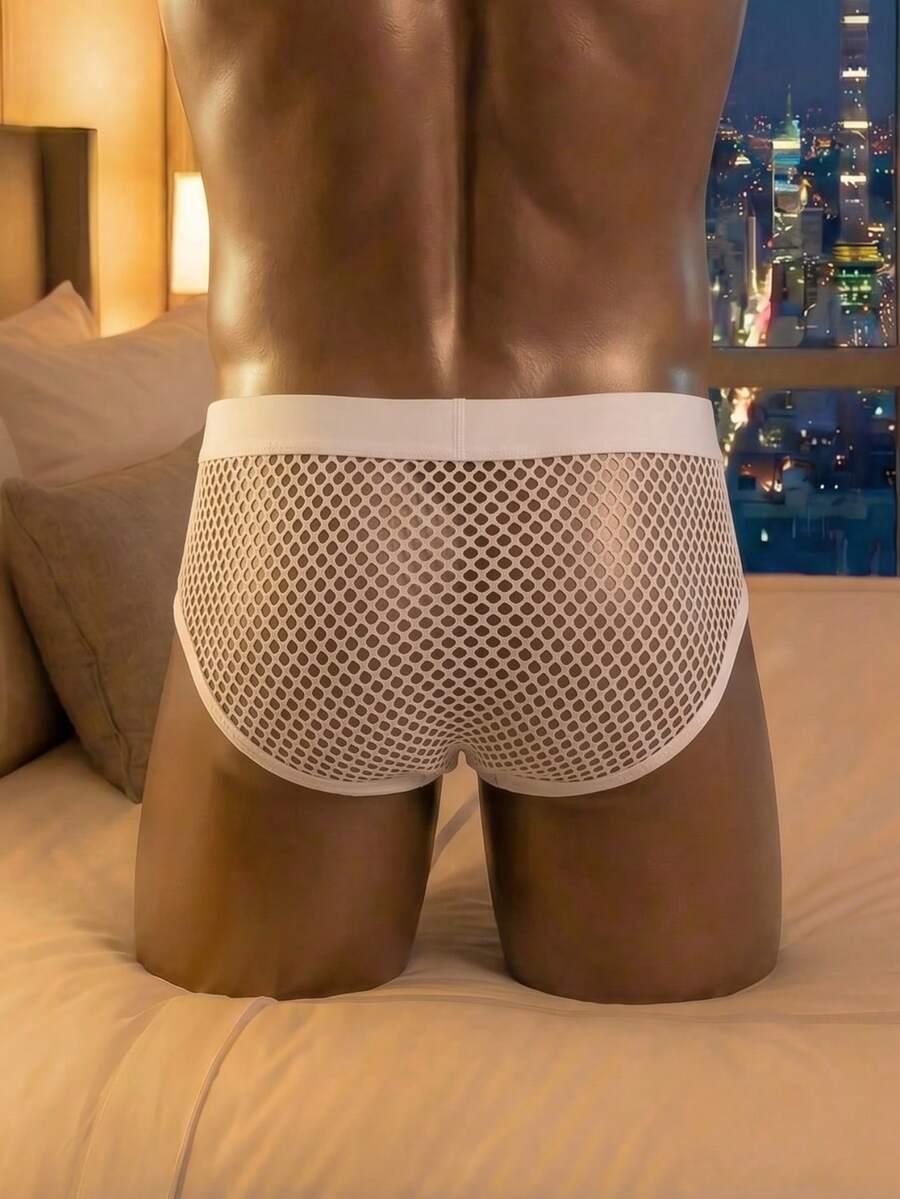 White hollow out mesh briefs for men featuring a low rise design and knitted polyester fabric.
