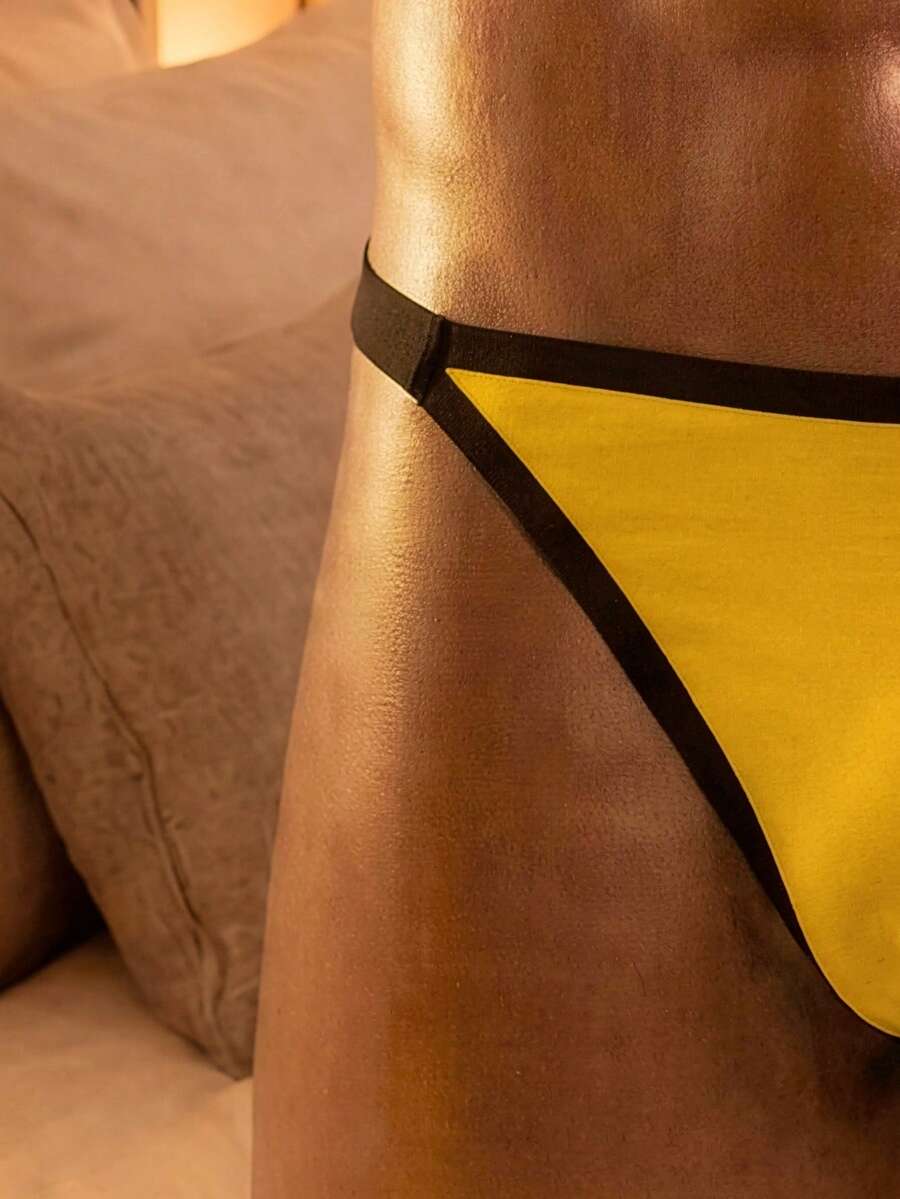 Yellow colorblock men's low rise thong underwear with contrast binding detail.