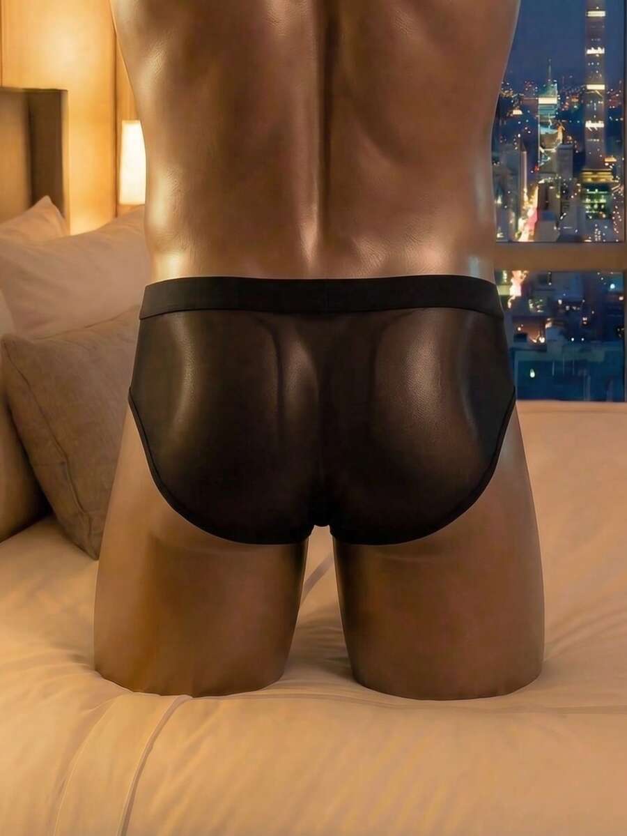 Men's black mesh briefs featuring a low rise cut and plain design made with medium stretch fabric.