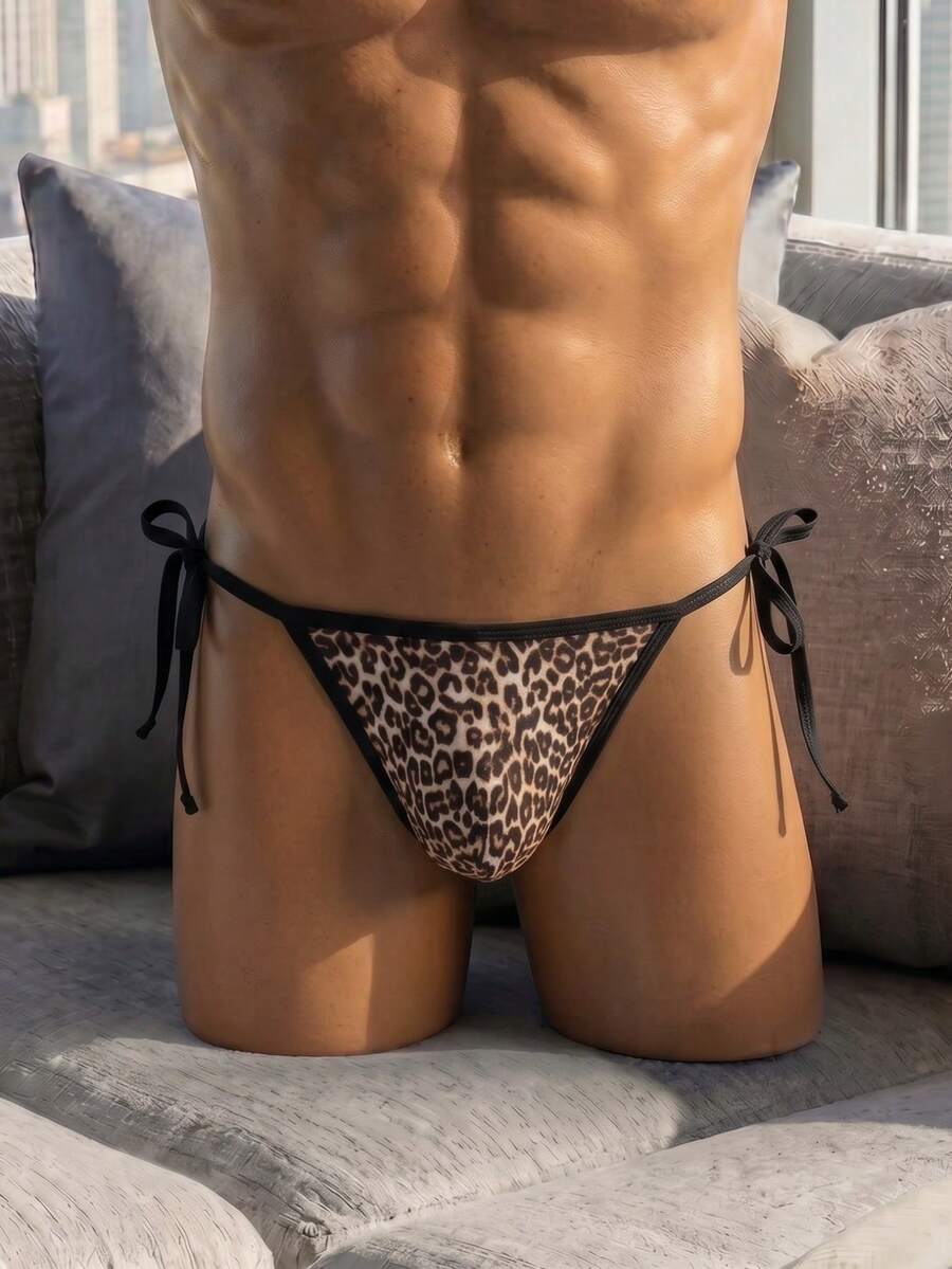 Multicolor leopard print men's low rise thong underwear made from stretch knitted fabric.