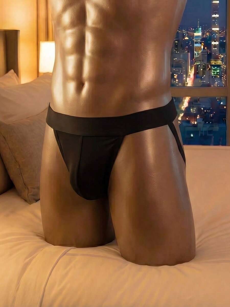Plain black men's low-rise backless jockstrap underwear featuring a double pouch crafted from stretch knitted fabric.