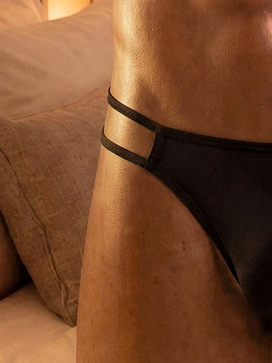 Black men's thong underwear with criss cross detail and low rise fit