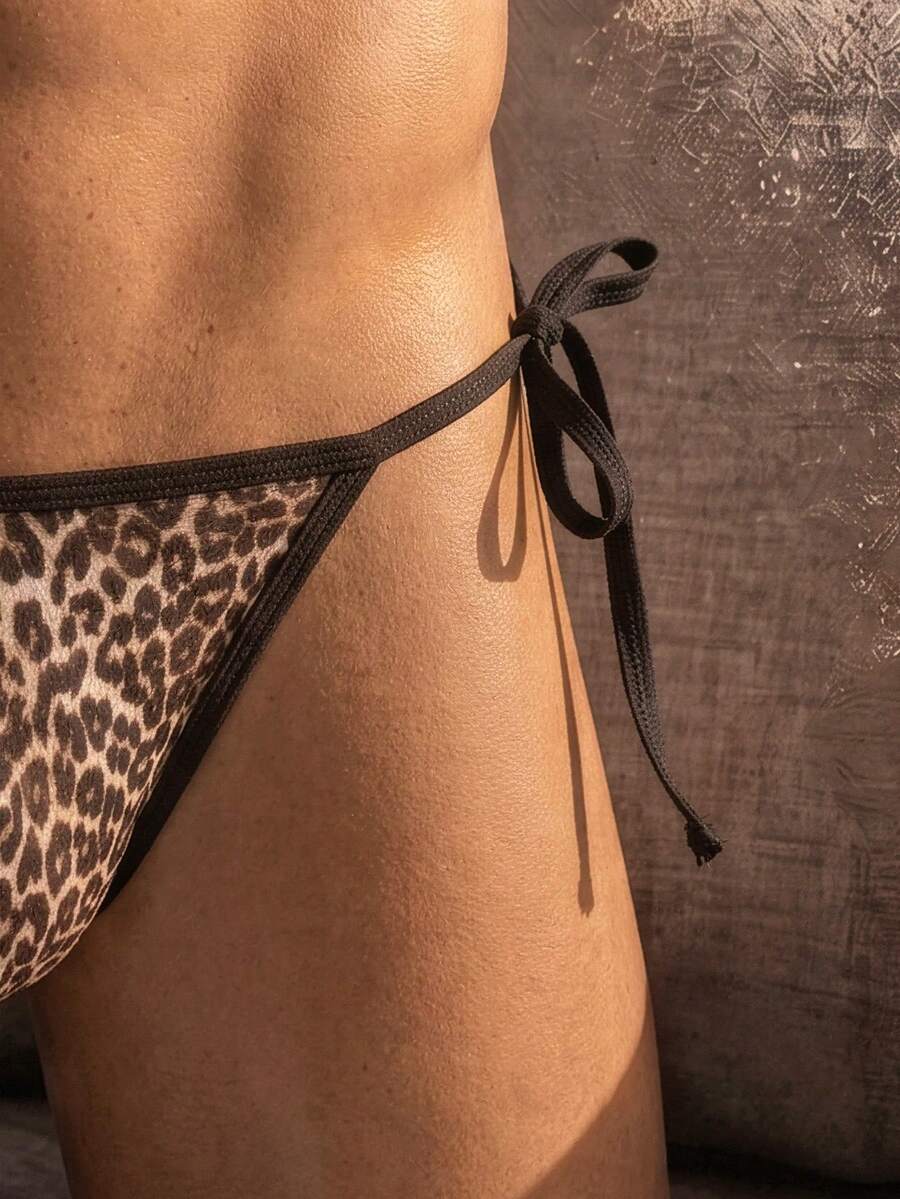 Multicolor leopard print men's low rise thong underwear made from stretch knitted fabric.