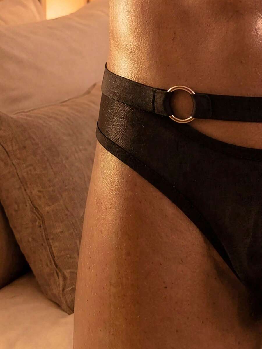 Men's black mesh briefs featuring a low rise cut and plain design made with medium stretch fabric.