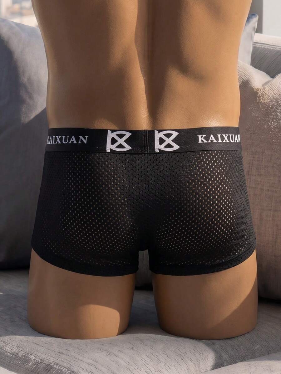 Men's solid black low rise cup boxer briefs crafted from polyamide stretch fabric