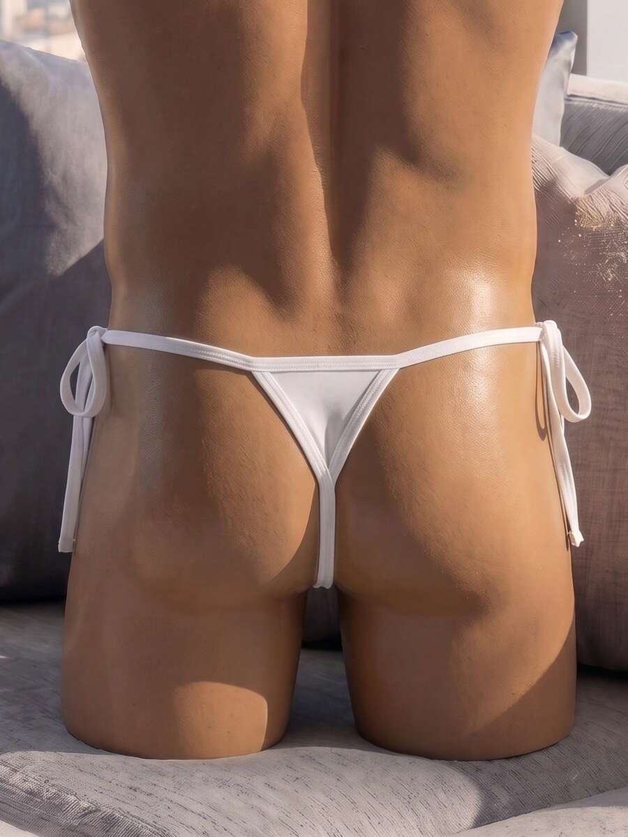Men's black knitted fabric low-rise thong underwear featuring knot detail.