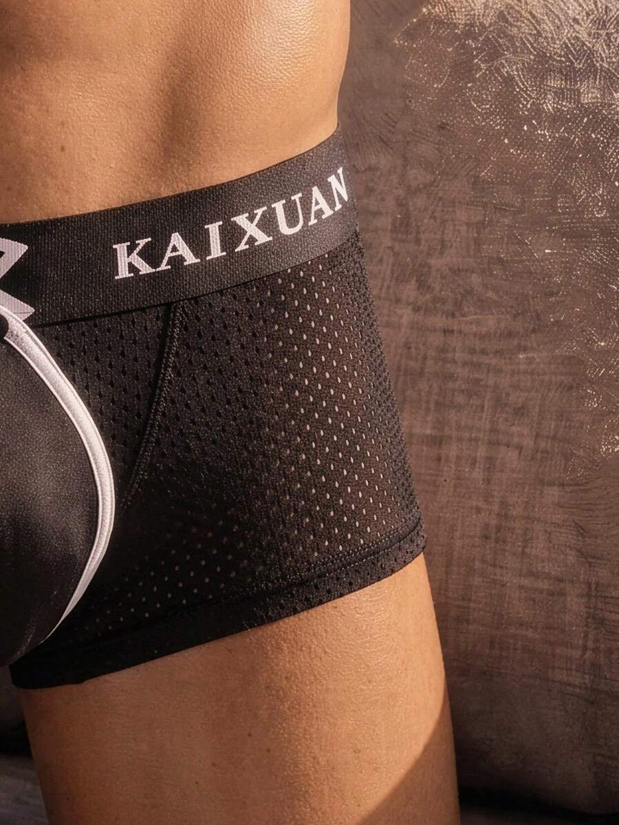 Men's solid black low rise cup boxer briefs crafted from polyamide stretch fabric