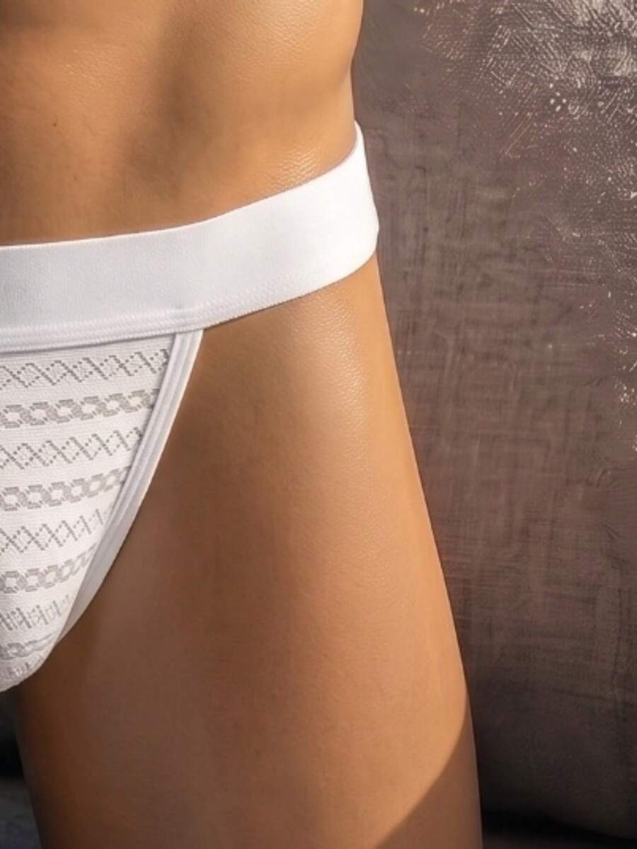 White low rise men's mesh thong underwear featuring a colorblock style.