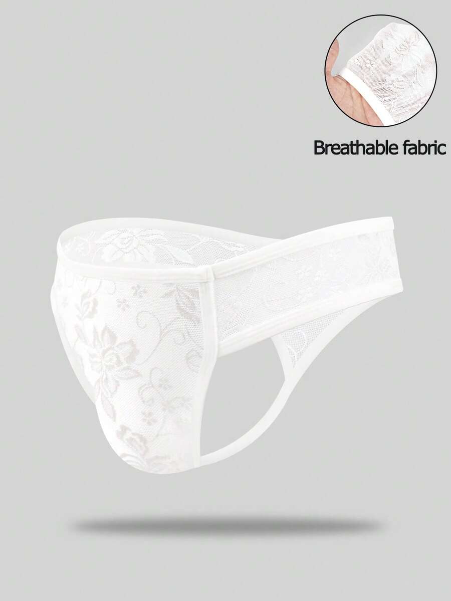 White lace thong underwear for men featuring a low rise waist and plant pattern knitted fabric.