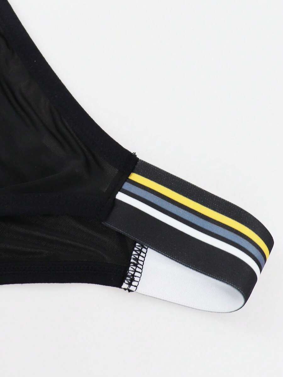 Black low-rise men's jockstrap underwear crafted from medium stretch knitted fabric.