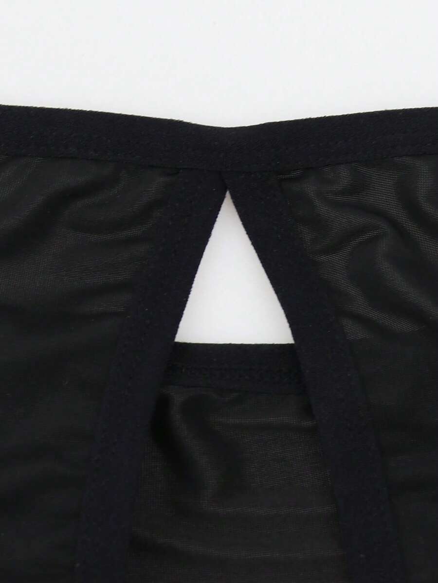 Black low-rise men's jockstrap underwear crafted from medium stretch knitted fabric.