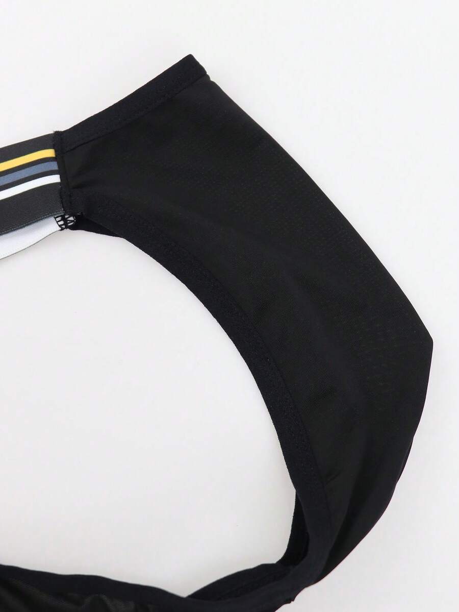 Black low-rise men's jockstrap underwear crafted from medium stretch knitted fabric.