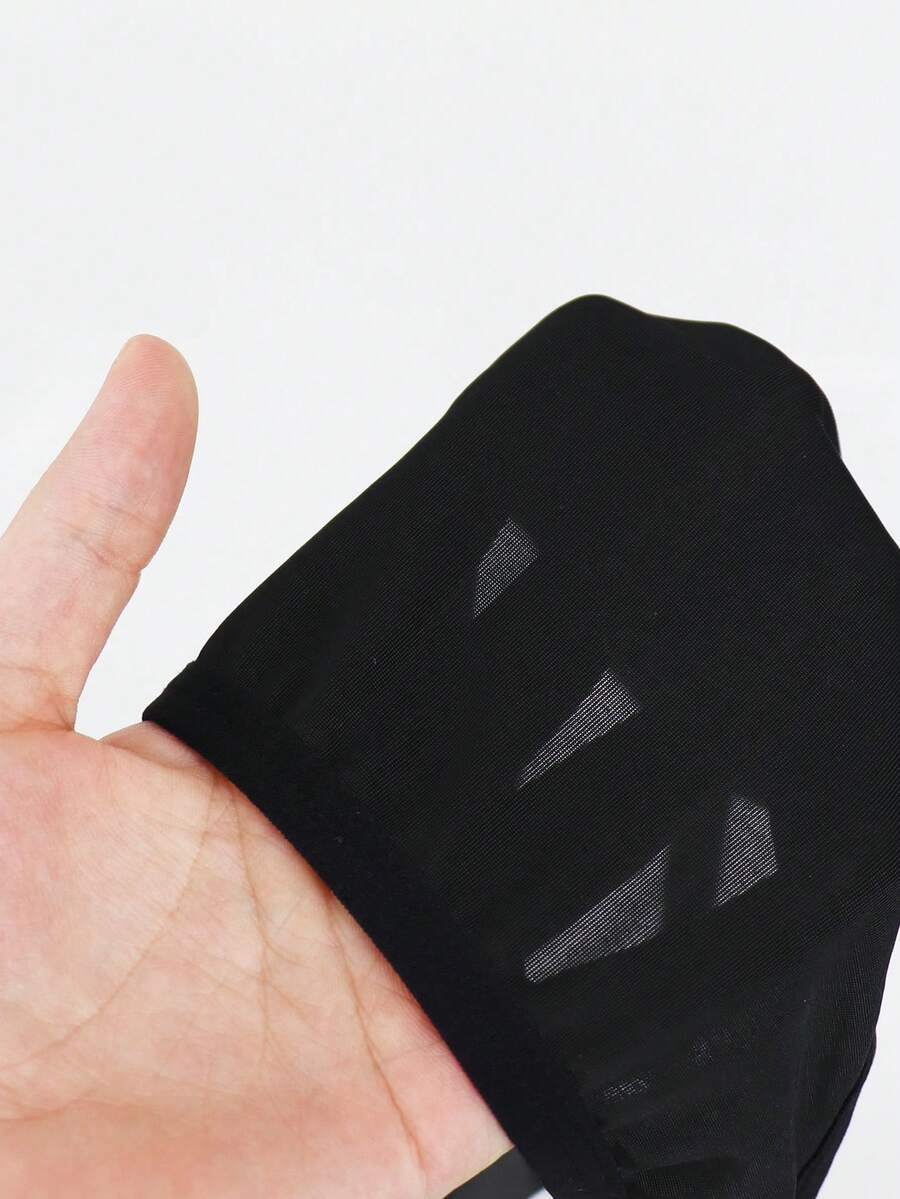 Black low-rise men's jockstrap underwear crafted from medium stretch knitted fabric.
