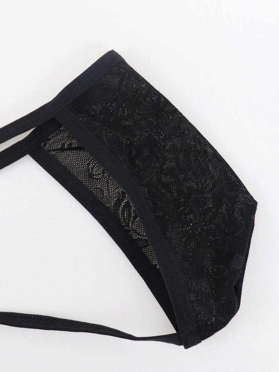 Men's black mesh thong underwear featuring a low-rise fit and backless design.