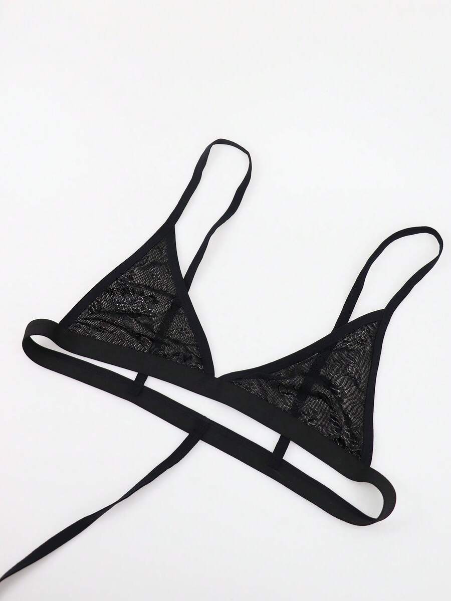 Men's black mesh thong underwear featuring a low-rise fit and backless design.