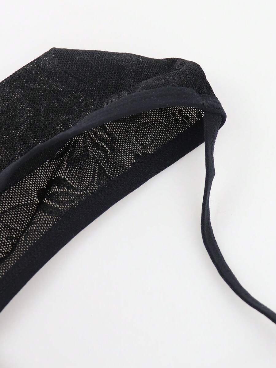 Men's black mesh thong underwear featuring a low-rise fit and backless design.