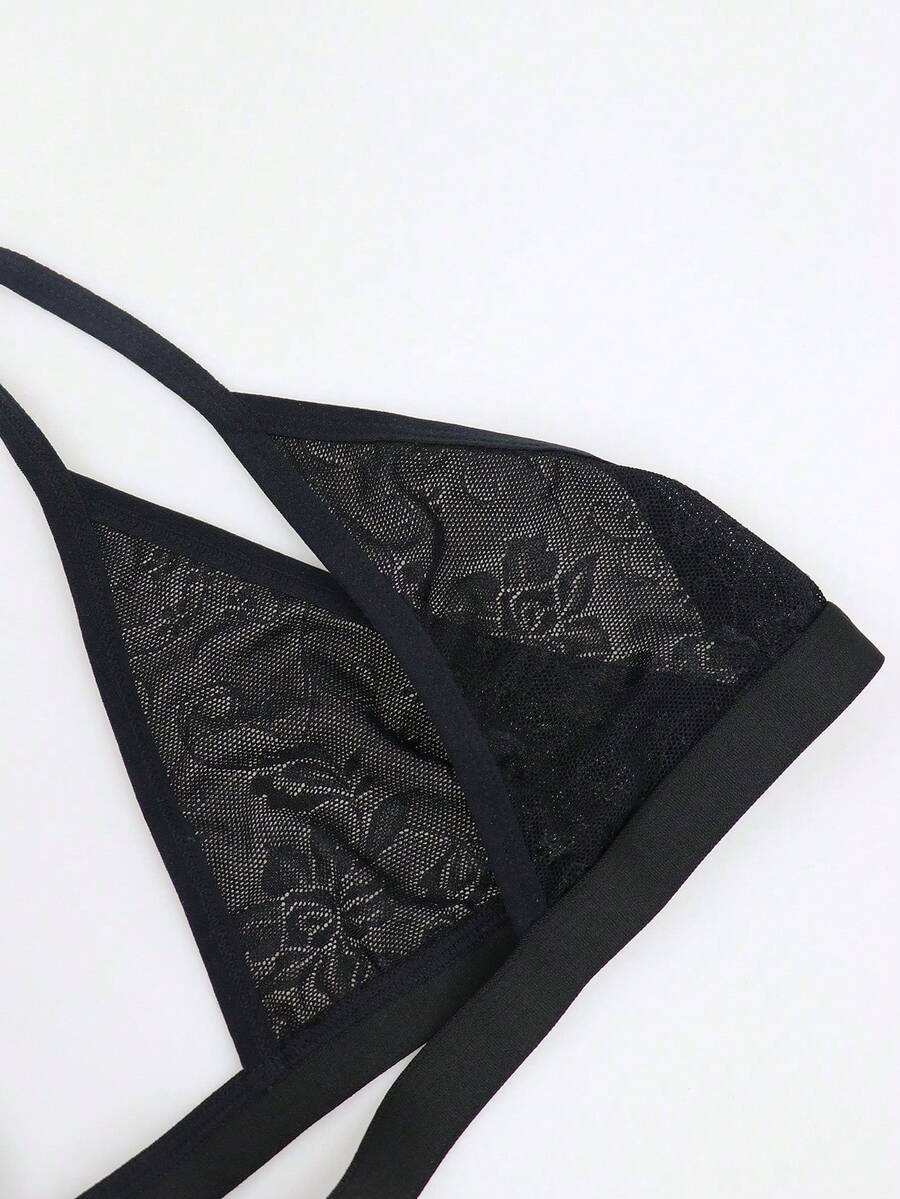 Men's black mesh thong underwear featuring a low-rise fit and backless design.