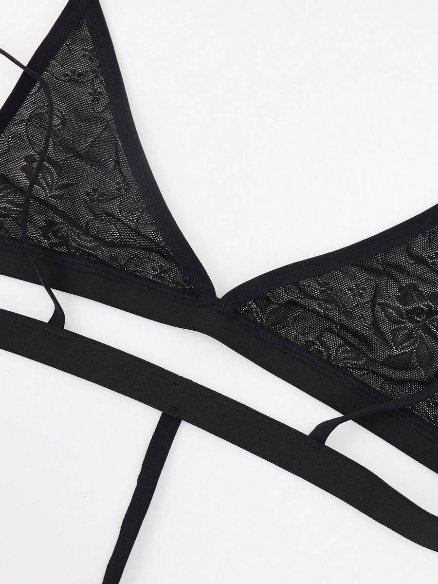 Men's black mesh thong underwear featuring a low-rise fit and backless design.