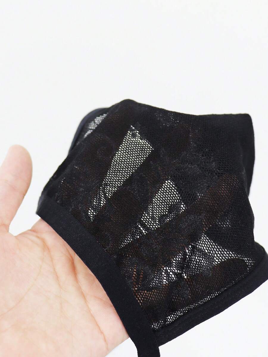 Men's black mesh thong underwear featuring a low-rise fit and backless design.