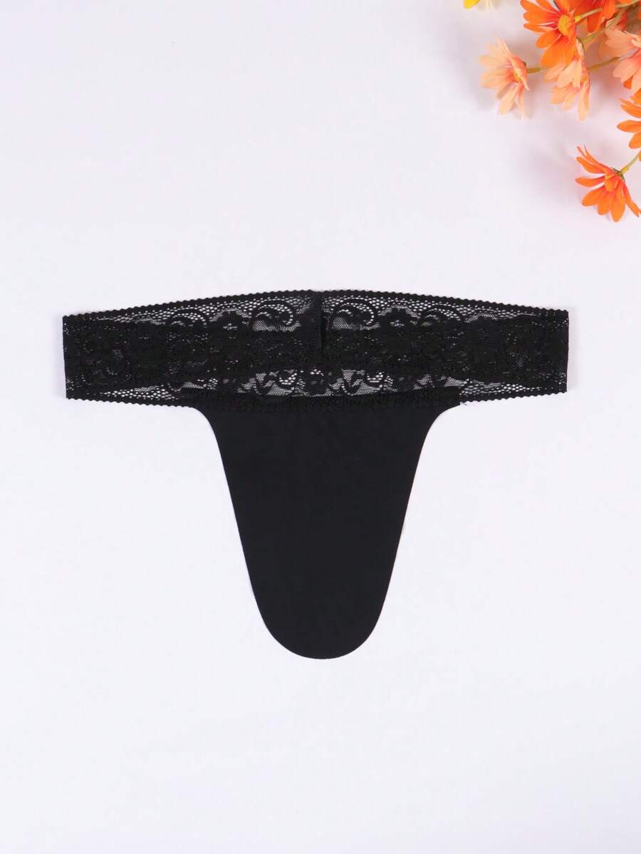 Black men's low rise thong underwear featuring a letter printed waistband and tape details.
