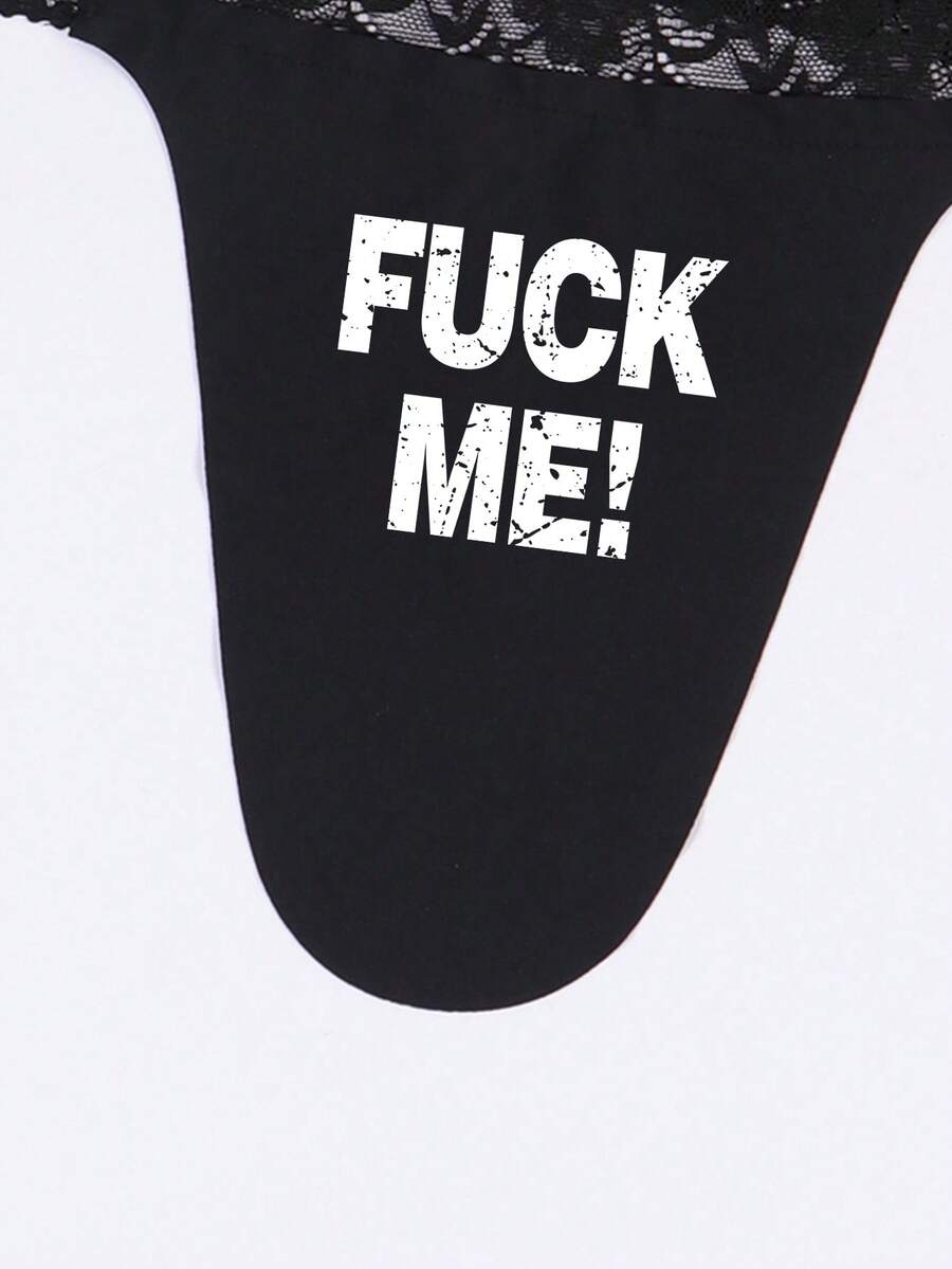 Black men's low rise thong underwear featuring a letter printed waistband and tape details.
