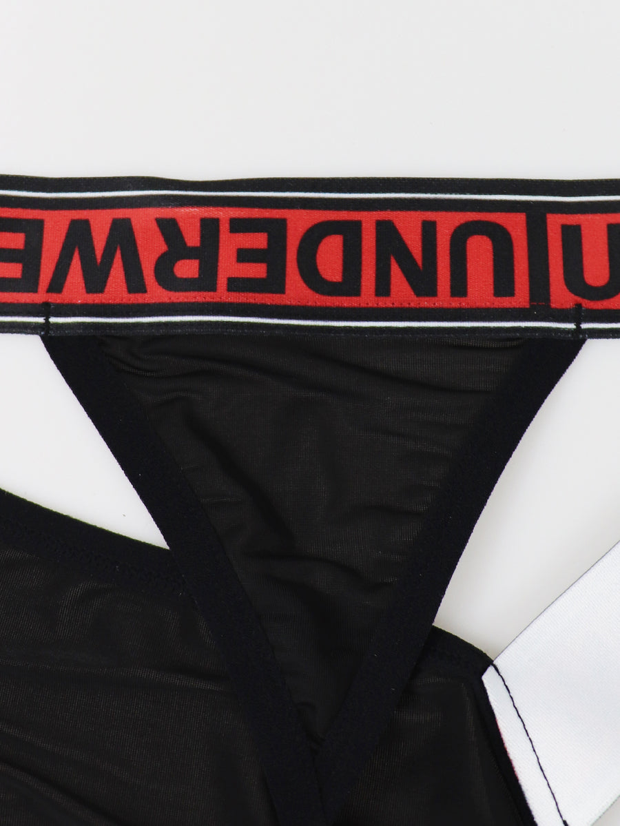 Black low rise men's thong underwear crafted from solid knitted stretch fabric.