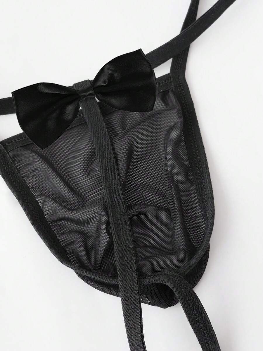 Black semi-sheer mesh men's thong featuring a Halloween theme, low-rise waist, front bow accent, and contrast binding.