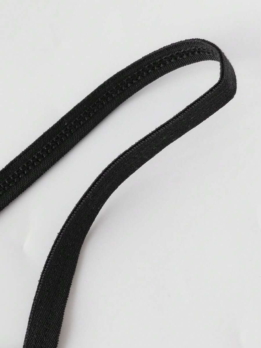Black semi-sheer mesh men's thong featuring a Halloween theme, low-rise waist, front bow accent, and contrast binding.