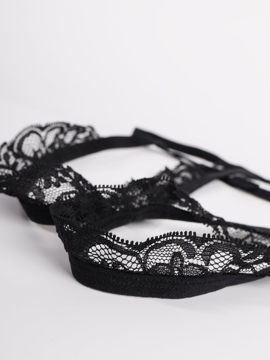 Men's black low-rise lace trim thong underwear featuring ring details and medium stretch knitted fabric.