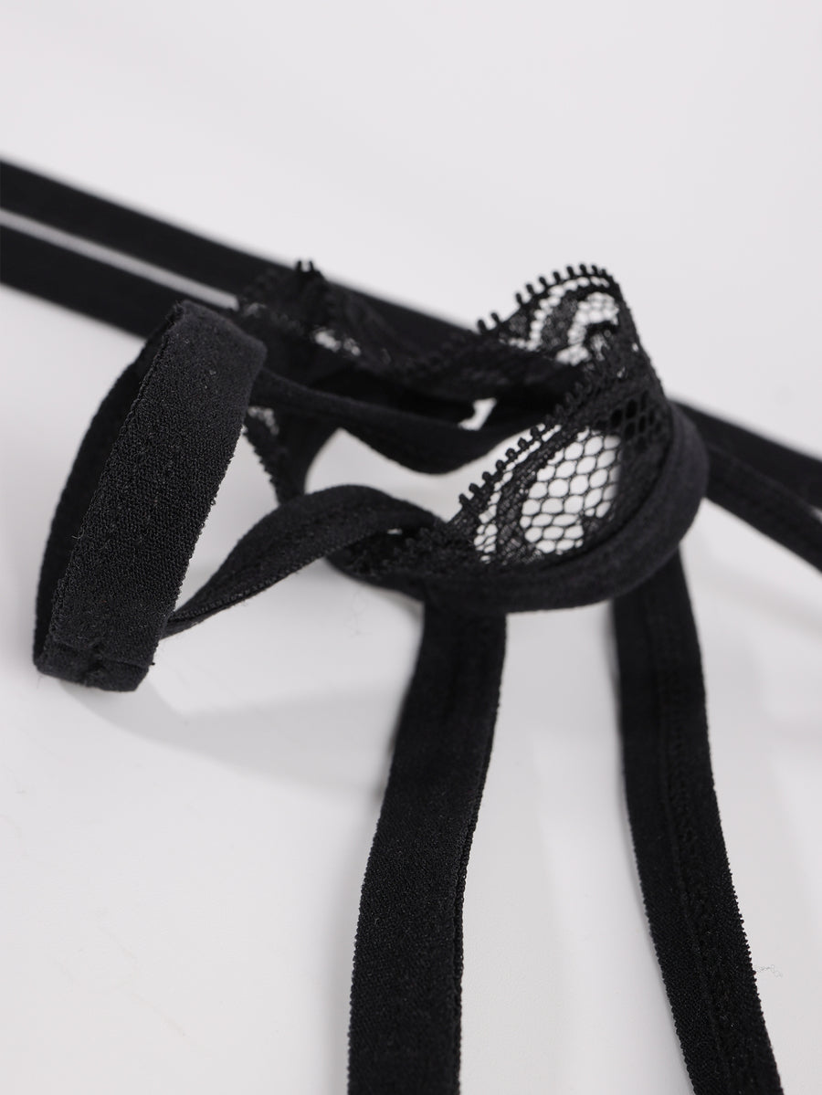 Men's low rise black thong underwear with lace patchwork trim