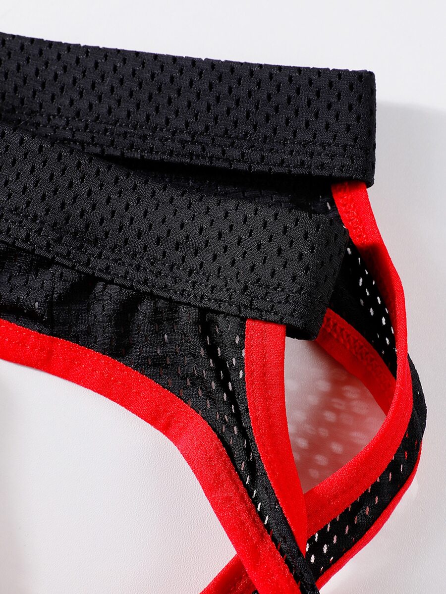 Black low rise men's contrast color thong with V neck and Christmas pattern design.