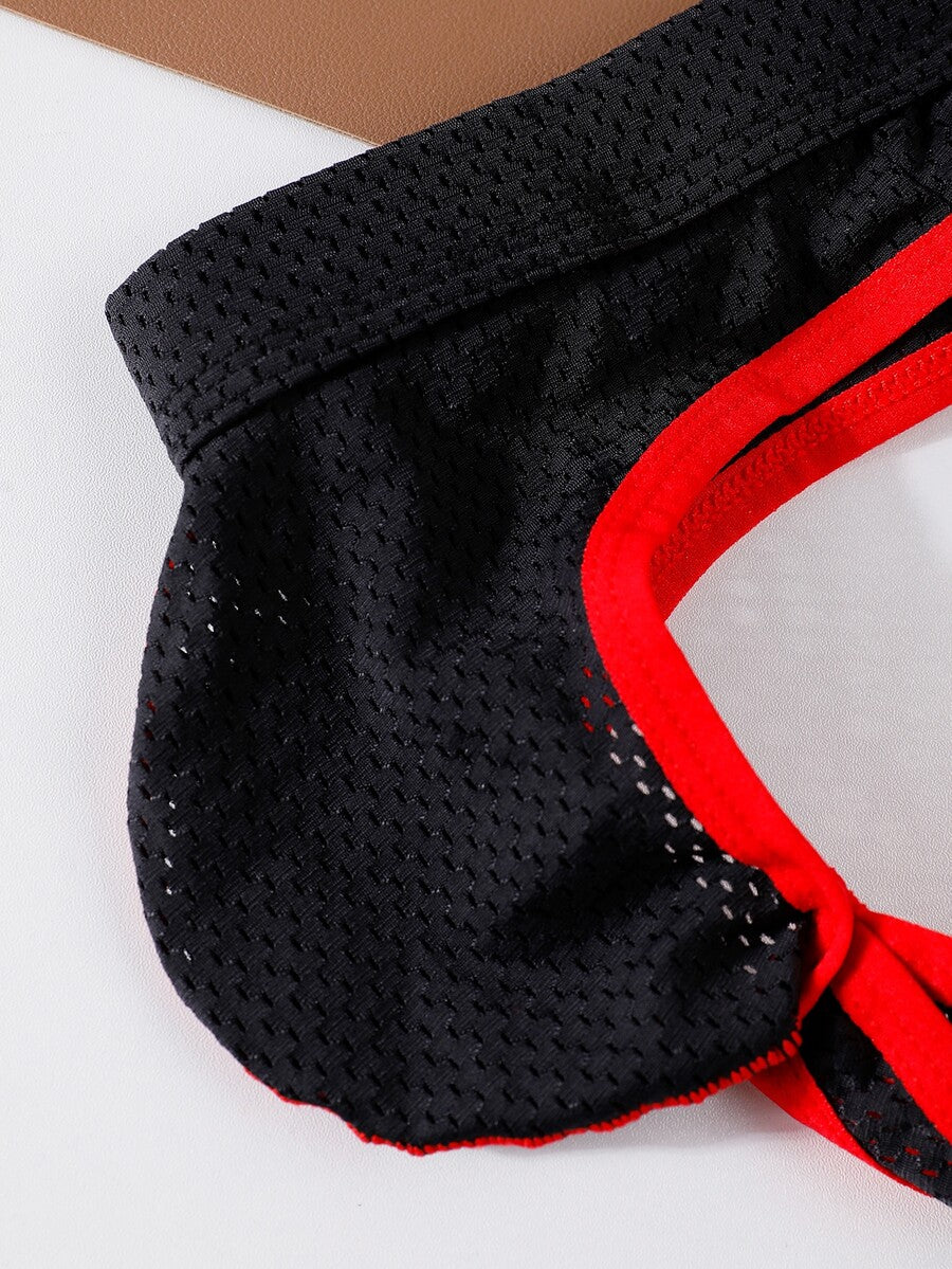 Black low rise men's contrast color thong with V neck and Christmas pattern design.