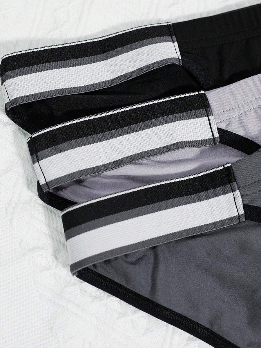 3-pack set of men's high-cut briefs featuring colorblock and plaid patterns with a striped waistband and mid-rise fit.